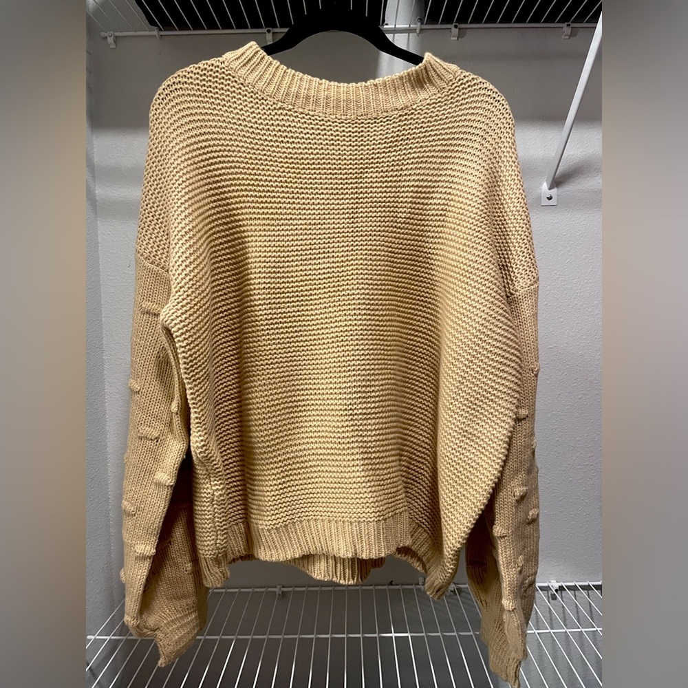 boutique like tan sweater with dotted accents on the arms